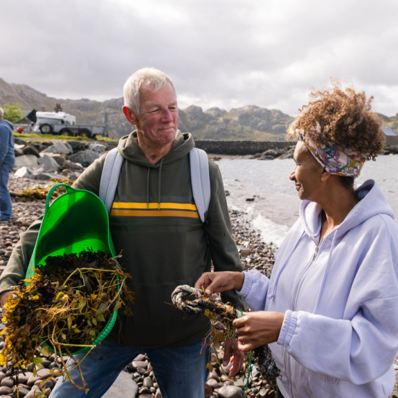 Two people foraging on the beach