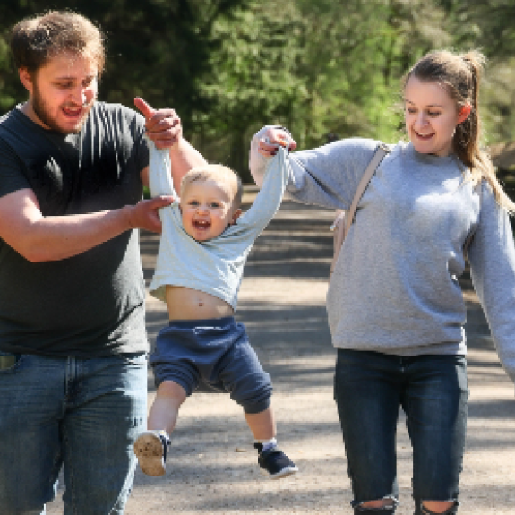 Couple lifting child